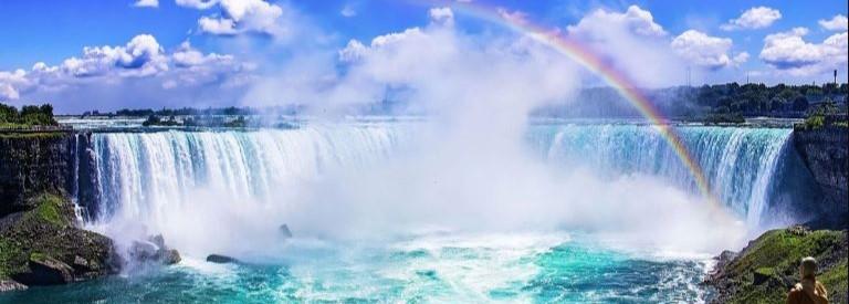 A beautiful view of Niagara Falls with a rainbow.