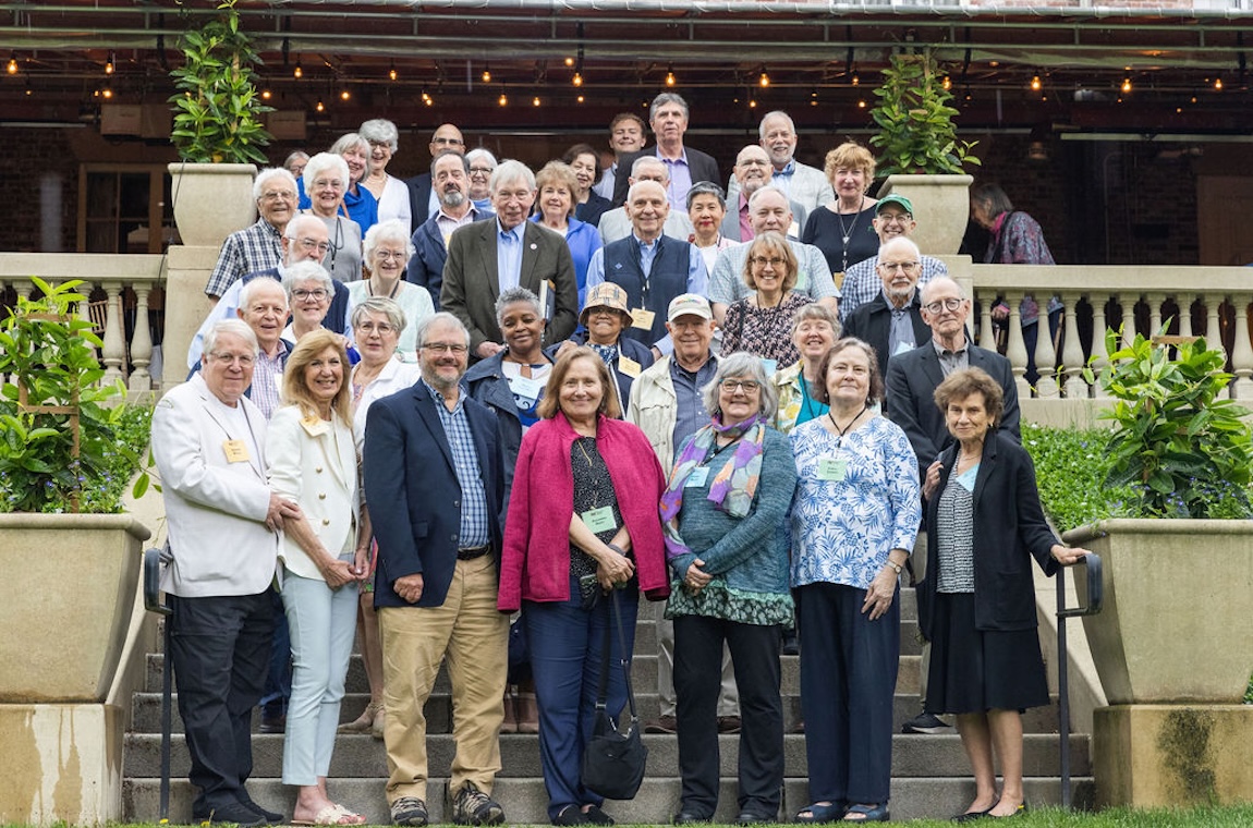 Event attendees gather for a group photo on the lawn of Endicott House
