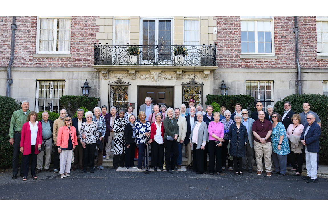 Event attendees gather for a group photo on the front porch of Endicott House
