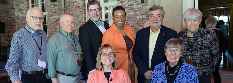Six attendees join Robert Dimmick and Melissa Nobles for a smiling photo